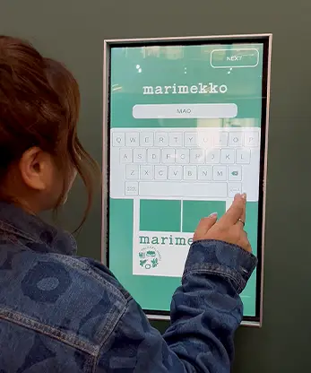 Marimekko visitor interacting touchscreen photo booth interface custom text Malaysia