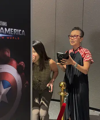 Maybank AI face swap touchscreen user interacting superhero selection Malaysia