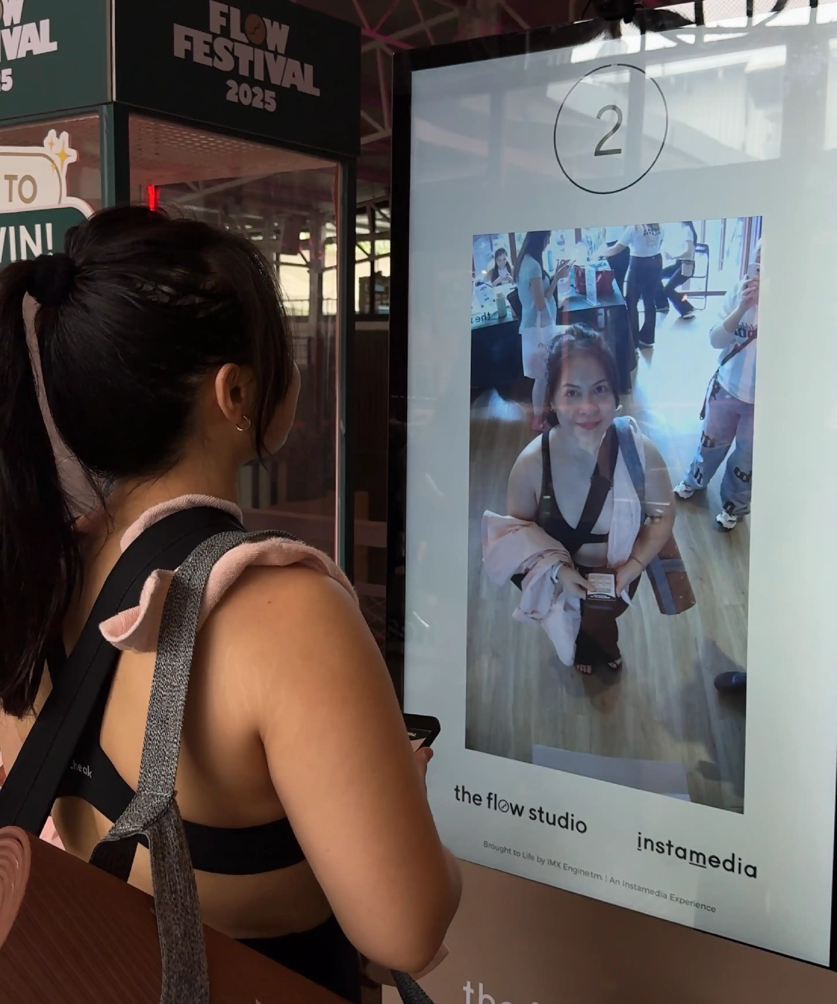 Flow Festival participants posing in front of interactive quiz photobooth