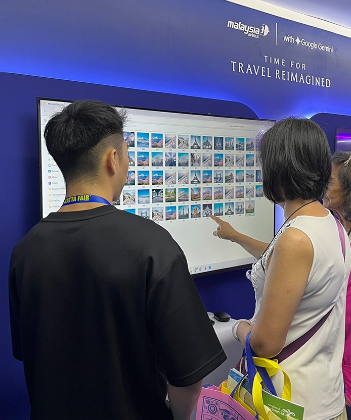MAS MATTA Fair staff explaining AI destination photobooth experience to visitors