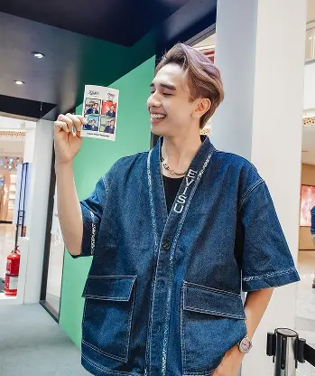 Kiehl's Bones' World Roadshow AI photo booth guest posing with Kiehl's product custom backdrop Malaysia