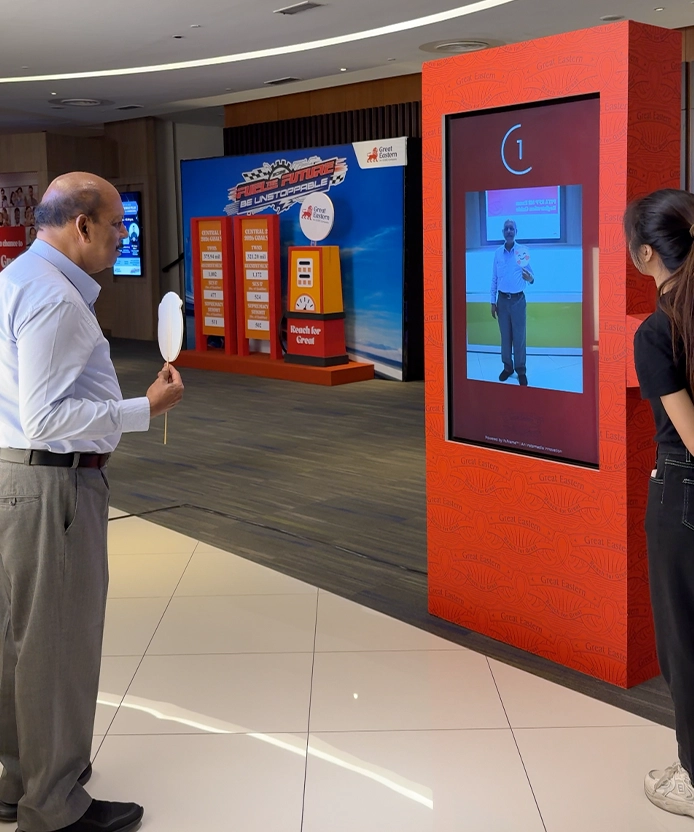 Attendees interacting with the Great Eastern photo booth kiosks at an event.