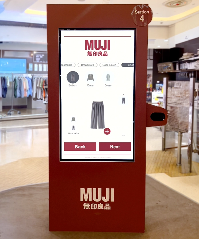 Full view of the red MUJI SS26 kiosk displaying the outfit builder interface.