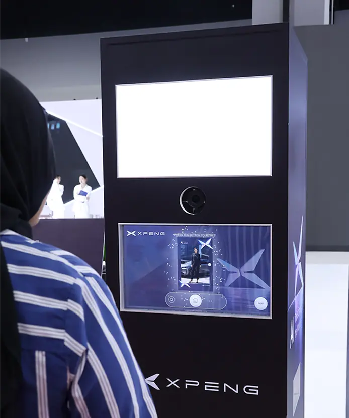 Guest reviewing her AI-generated futuristic XPENG portrait on the Instabox AI photo booth screen