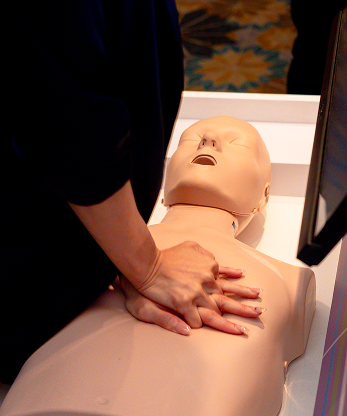 IHH instructor guiding a participant through hands-on CPR training technique, Malaysia