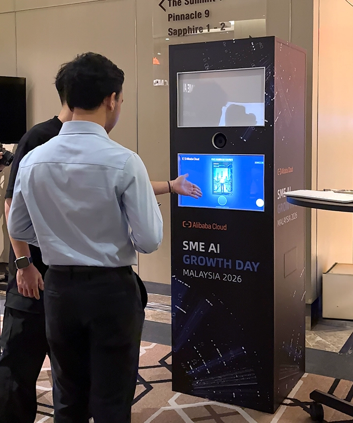 Attendee standing in front of the SME AI Growth Day interactive kiosk.