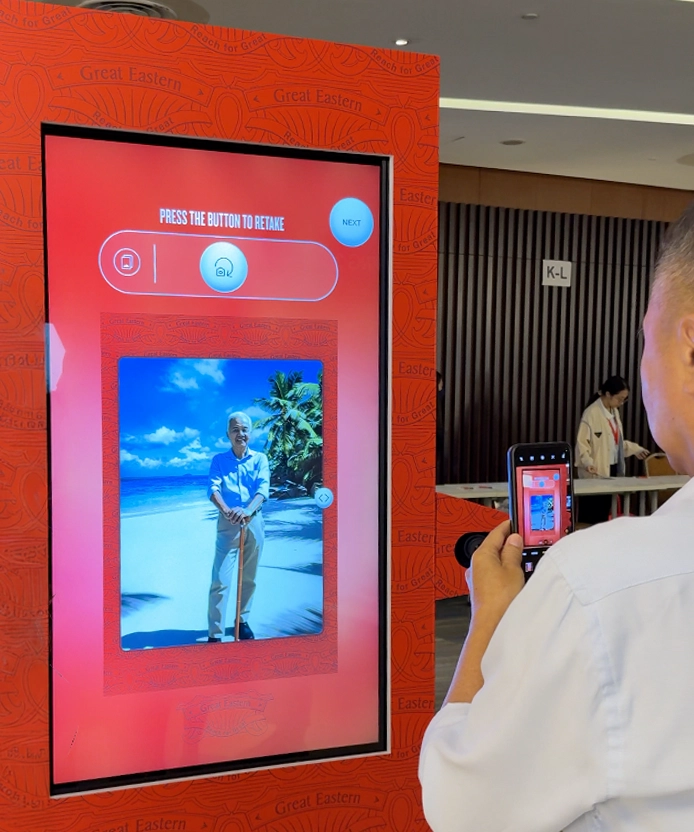 User scanning the kiosk QR code with a phone to retrieve their photo.