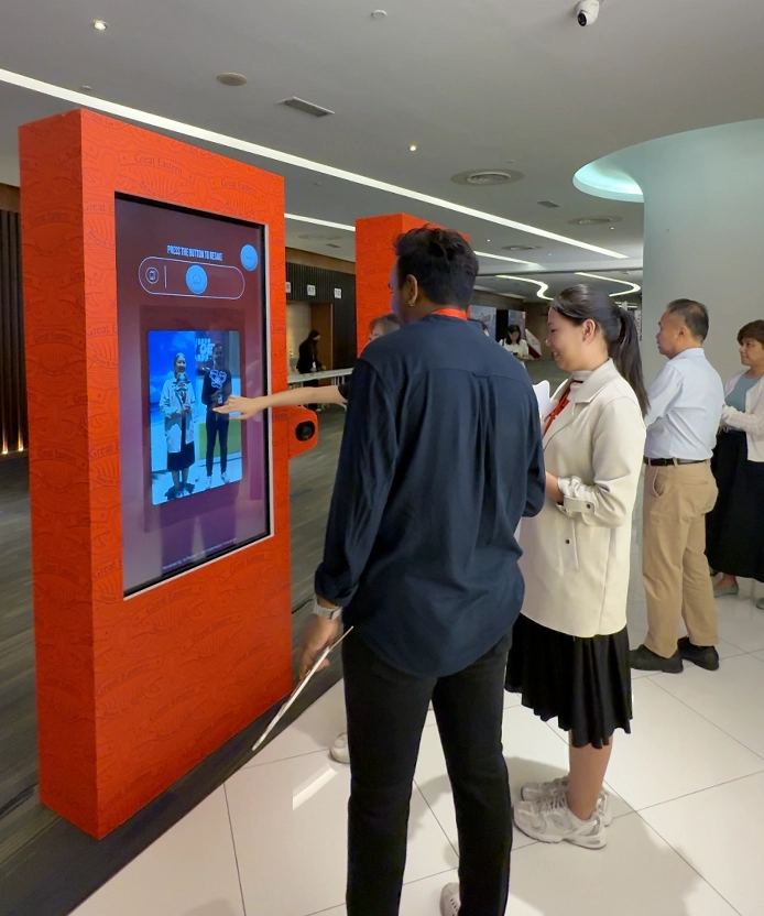 Guest interacting with the retake screen on the Great Eastern AI Retirement Pride photo kiosk, Malaysia