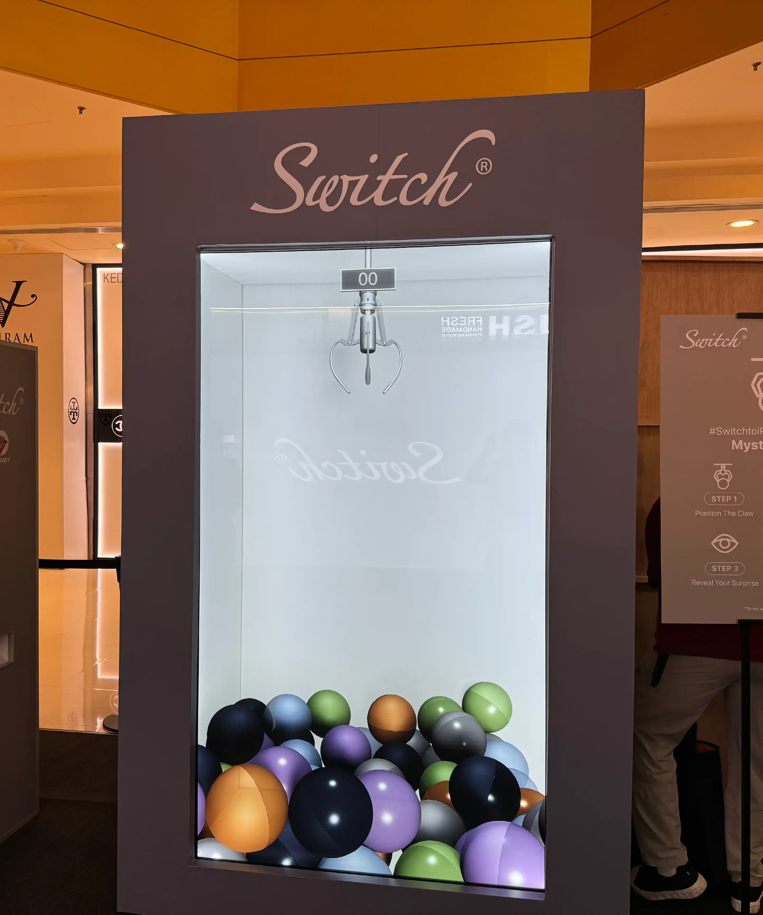 Switch iPhone 17 interactive event game setup at Sunway Pyramid, Kuala Lumpur, with iPad stations and 4K LED display