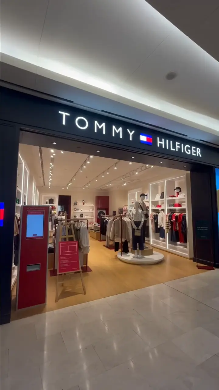Tommy Hilfiger storefront with illuminated signage and mannequin window at The Gardens Mall, Kuala Lumpur