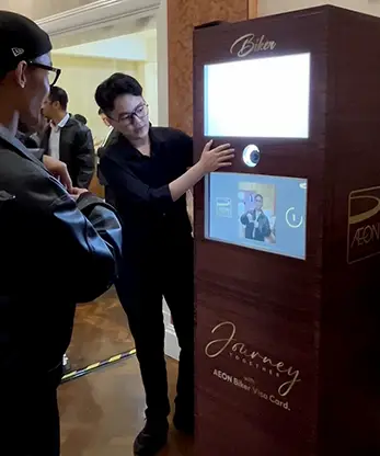 Staff assisting visitors at the Aeon Credit AI photo booth.