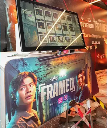 Visitors interacting with the Astro Framed game at the event.