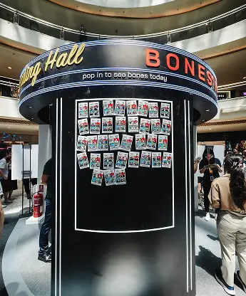 Kiehl's Bones' World Roadshow AI photo booth guest selecting photo on touchscreen interface Malaysia