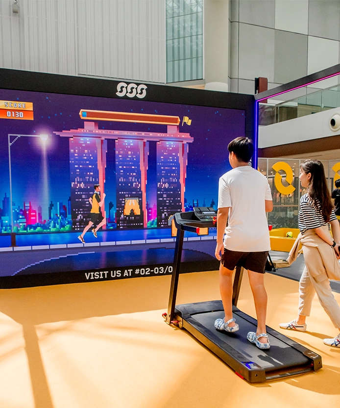 Sun & Sands Sports treadmill gaming activation, 8-bit Marina Bay Sands running game on LED screen, Singapore.