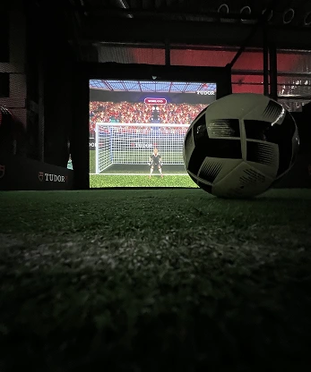 Tudor football projection game real ball close-up with AI goalkeeper on screen, Kuala Lumpur, Malaysia.