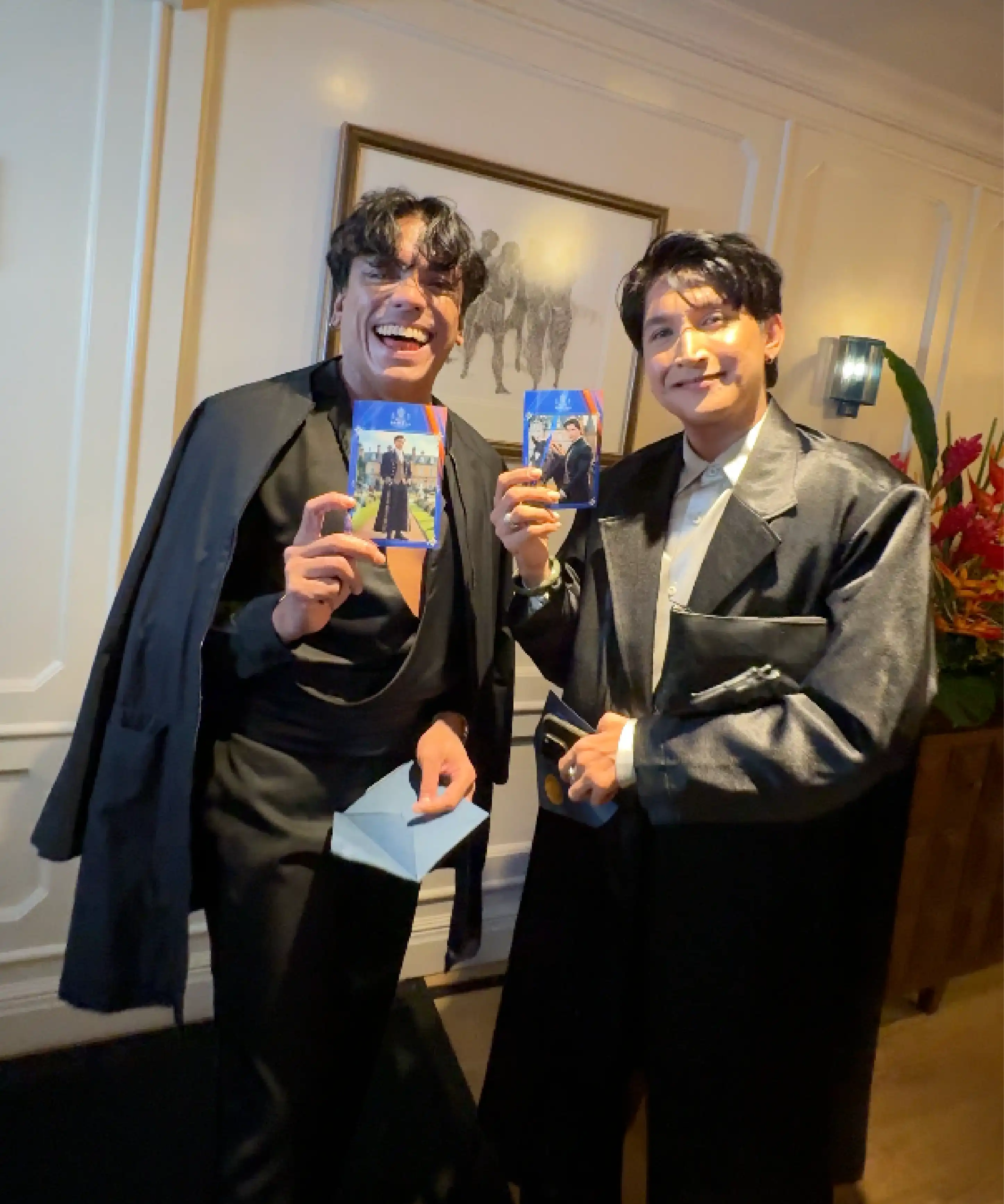 Guests laughing while holding printed Royal Brackla AI photos, Malaysia event