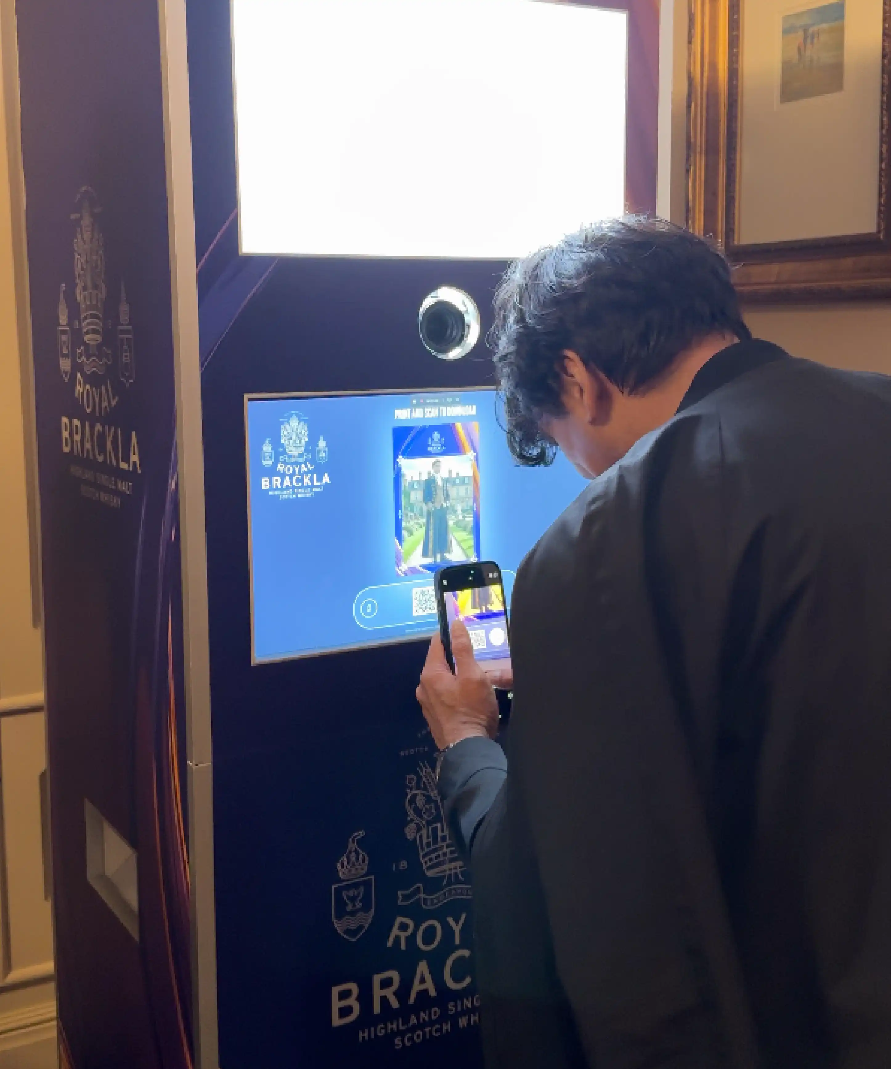 Guest scanning QR code at Royal Brackla Instabox photo booth, Malaysia whisky event