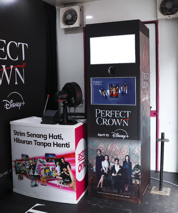 Perfect Crown photo booth kiosk with Disney+ branding next to an Astro One counter at the event booth.