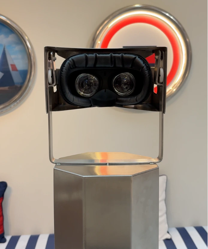 Close-up of the VR headset lenses inside the metal viewfinder mounted on a steel pedestal