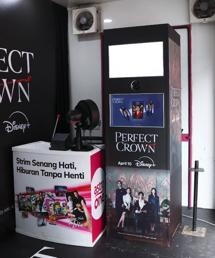 Perfect Crown photo booth kiosk with Disney+ branding next to an Astro One counter at the event booth.