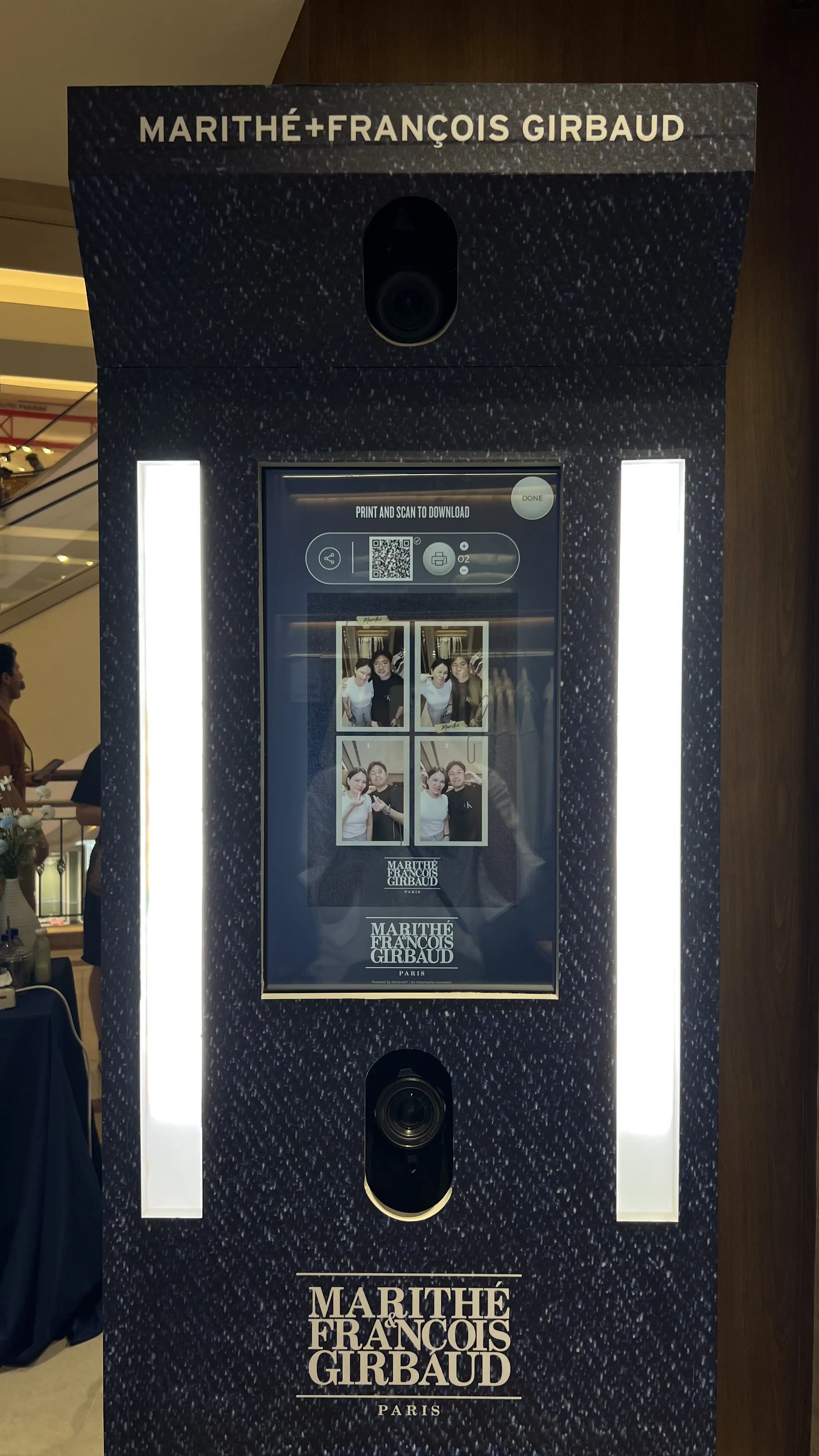 Booth touchscreen showing print and QR download options with four-photo layout