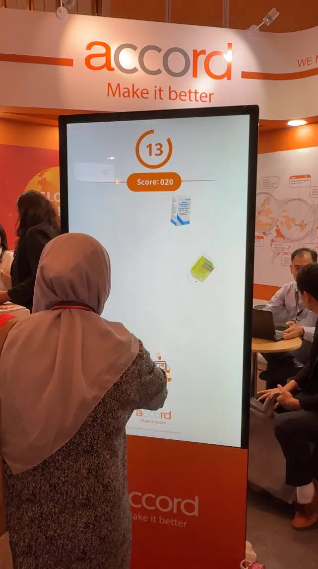 Attendee playing the medicine-catching game with live score and countdown timer