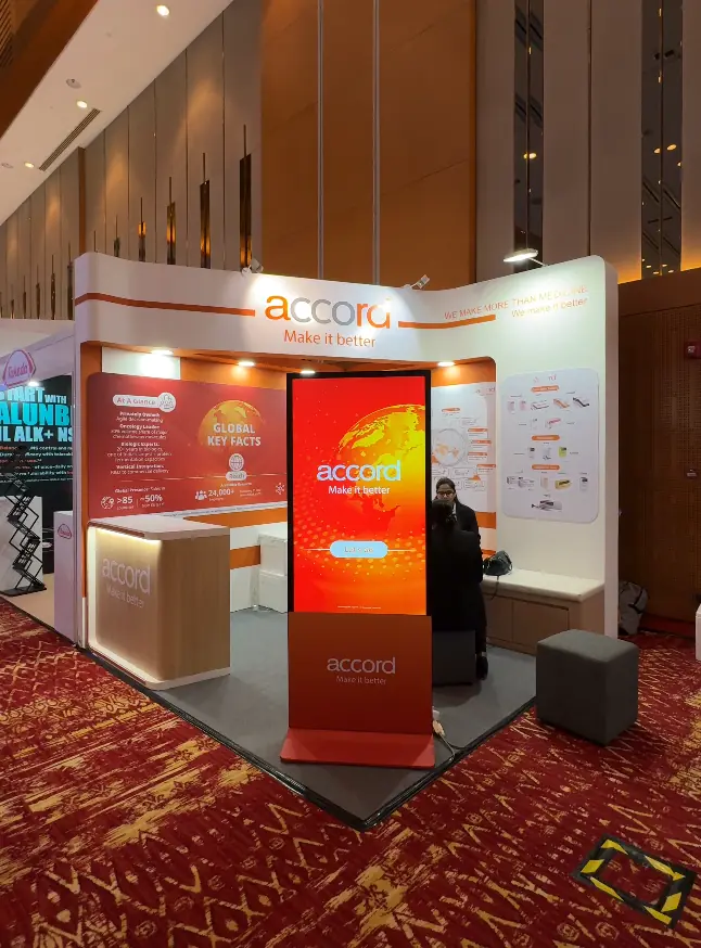 Wide view of the Accord Healthcare congress booth with game kiosk and seating