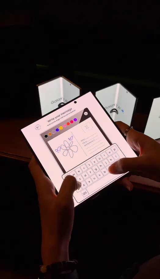 Guest drawing a flower message on the Samsung foldable postcard app