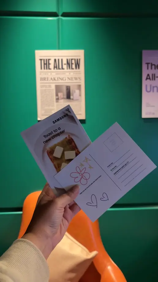 Hand holding Samsung Toast to a New Chapter postcards with hand-drawn message