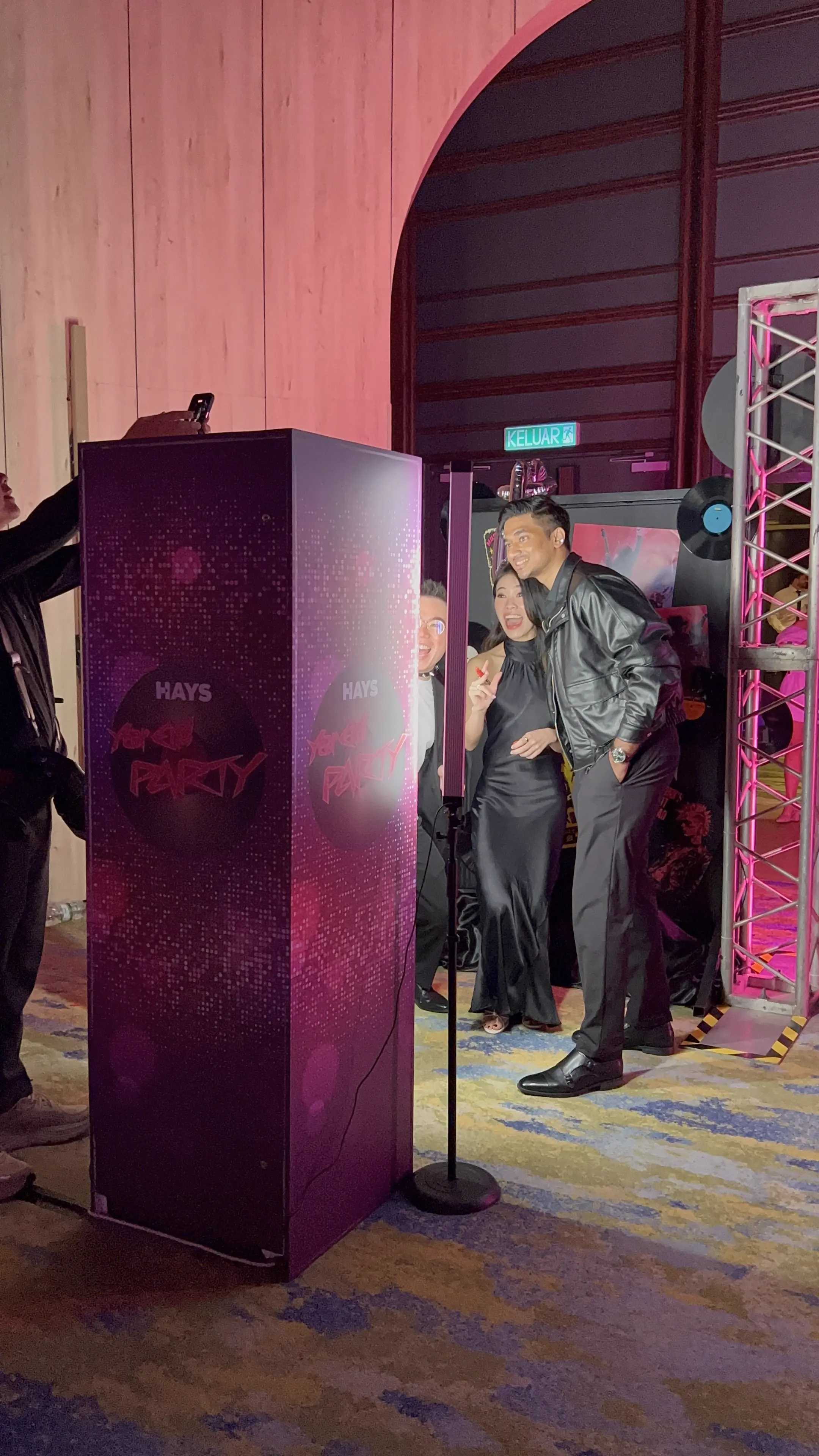 Guests posing together at the HAYS party photo booth