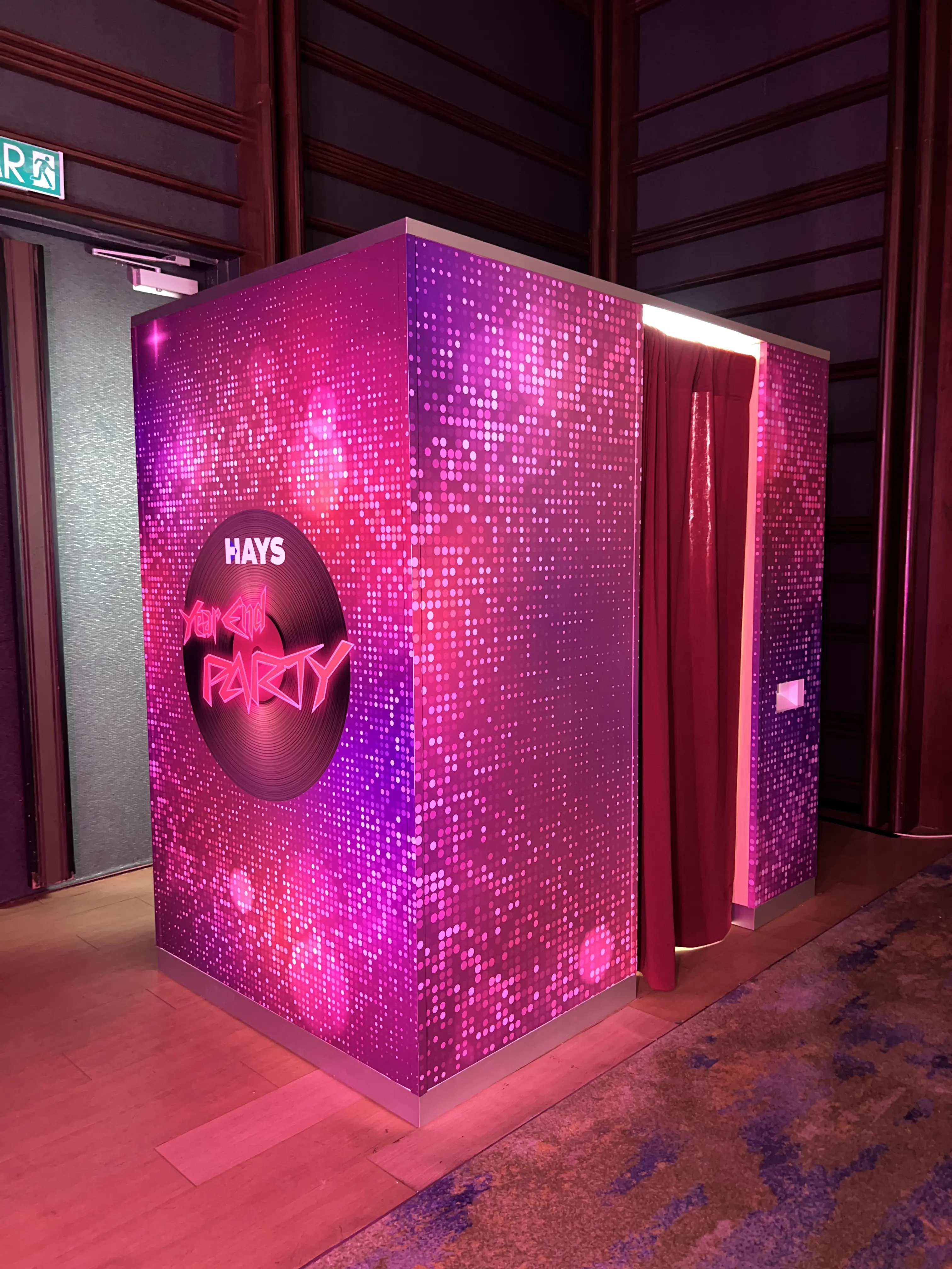 Pink sequin HAYS Instabooth 2.0 enclosure with red curtain at the ballroom