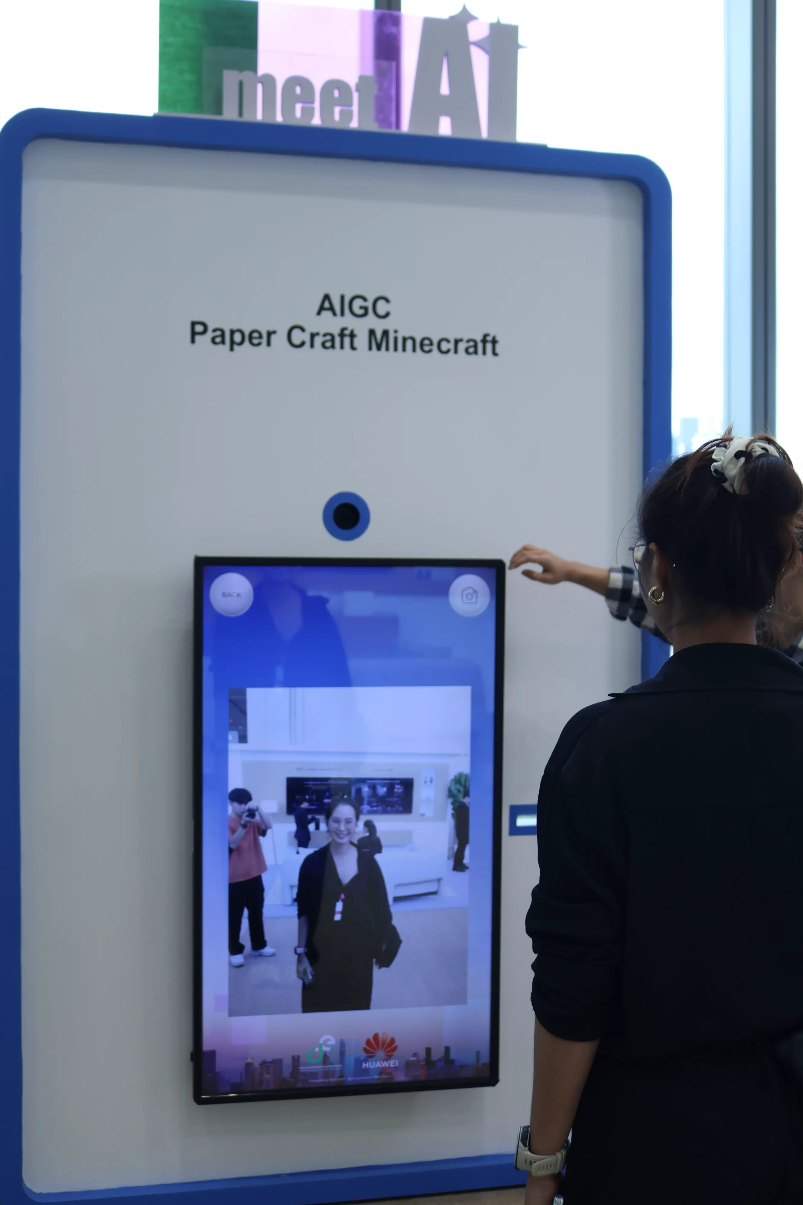 Guest using the AI photo booth camera screen to capture her portrait