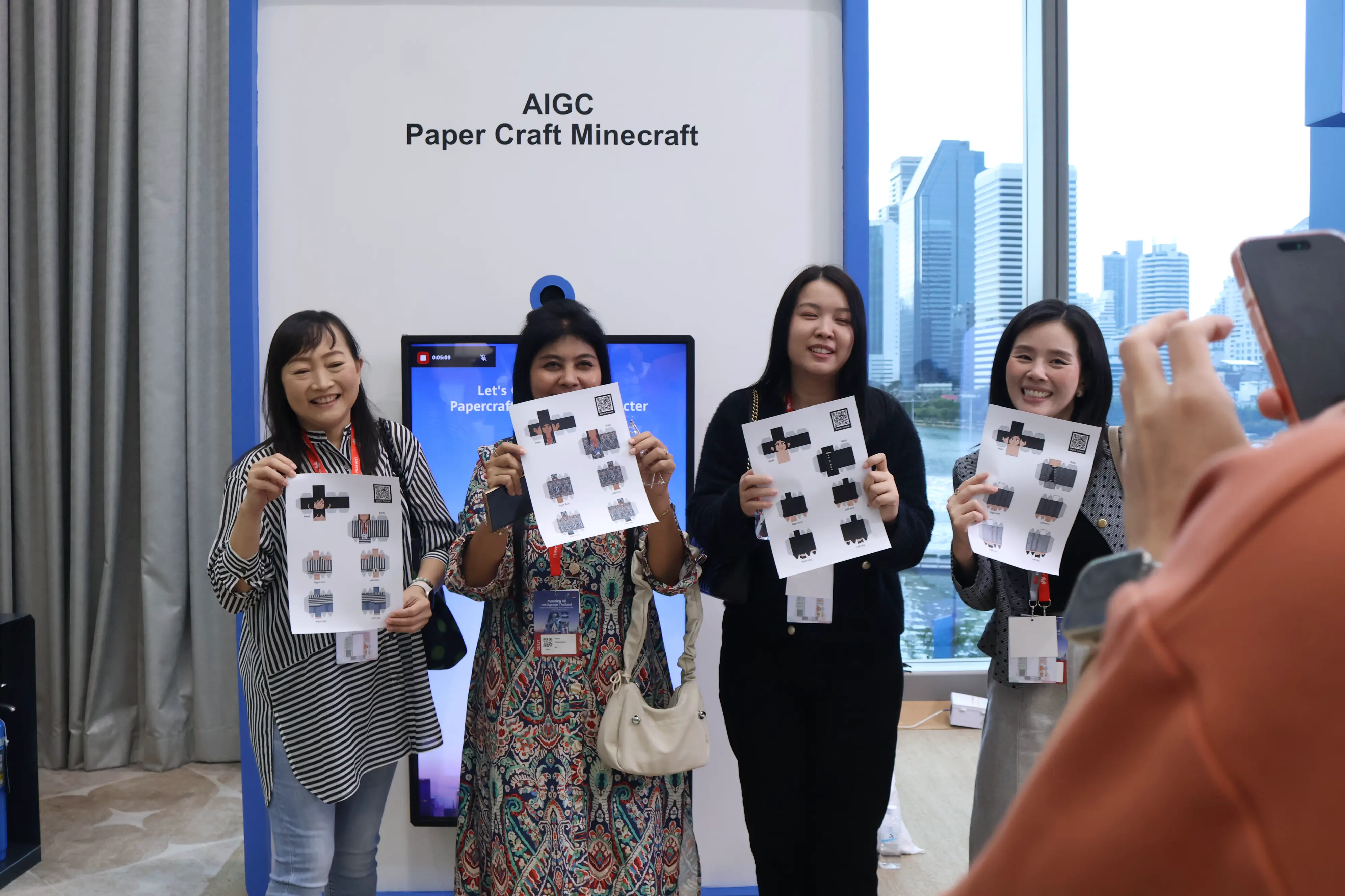 Four delegates showing their personalised papercraft Minecraft sheets