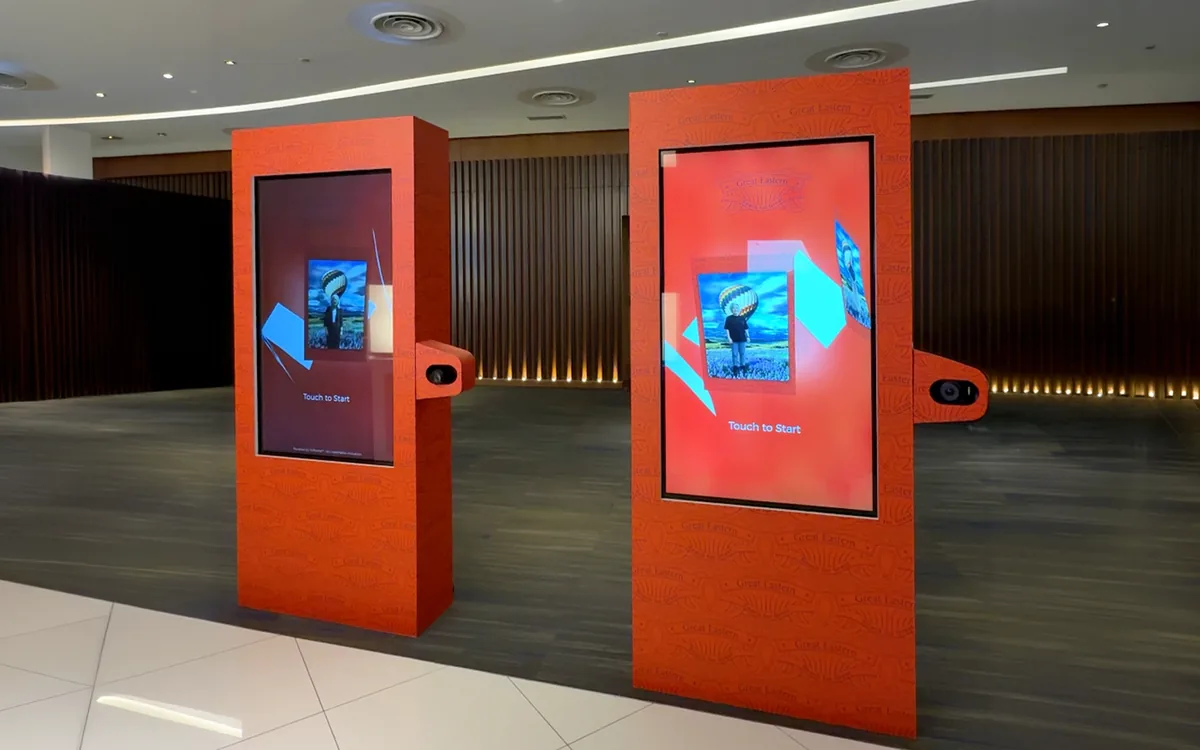Two red Great Eastern AI photo booth kiosks at the Great Retirement Pride launch