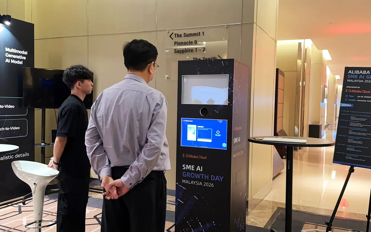 Two attendees at the Alibaba Qwen AI photo booth kiosk at SME Growth AI Malaysia 2026