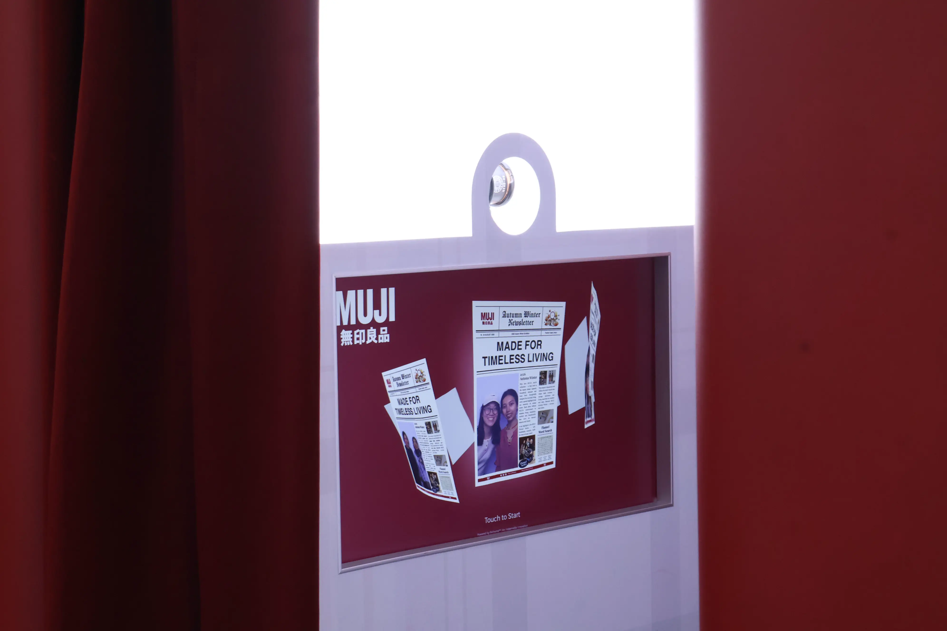 Booth touchscreen showing the MUJI Autumn Winter Newsletter photo layout and Touch to Start