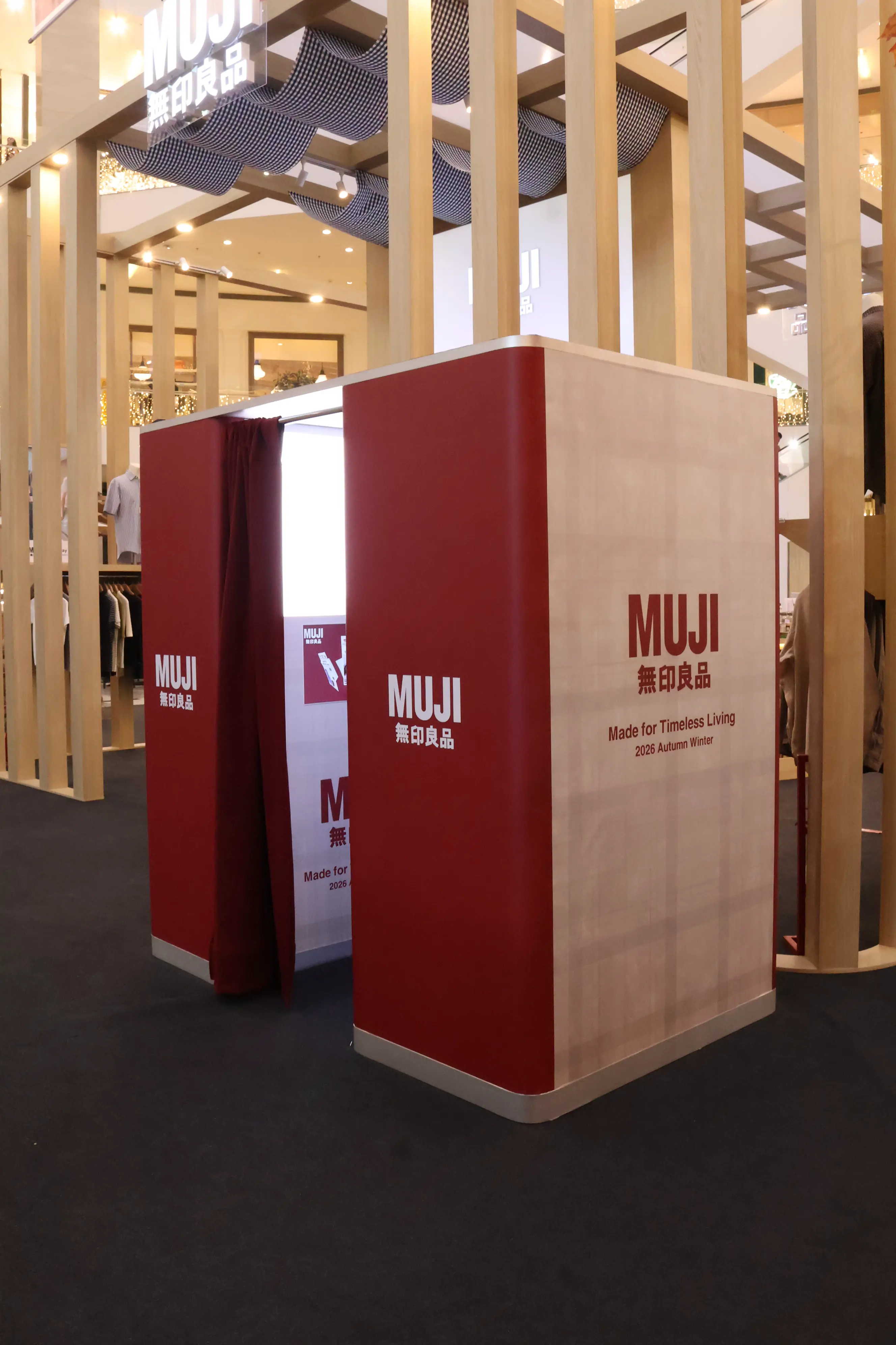 Red and wood MUJI photo booth with curtain at the Made for Timeless Living exhibition