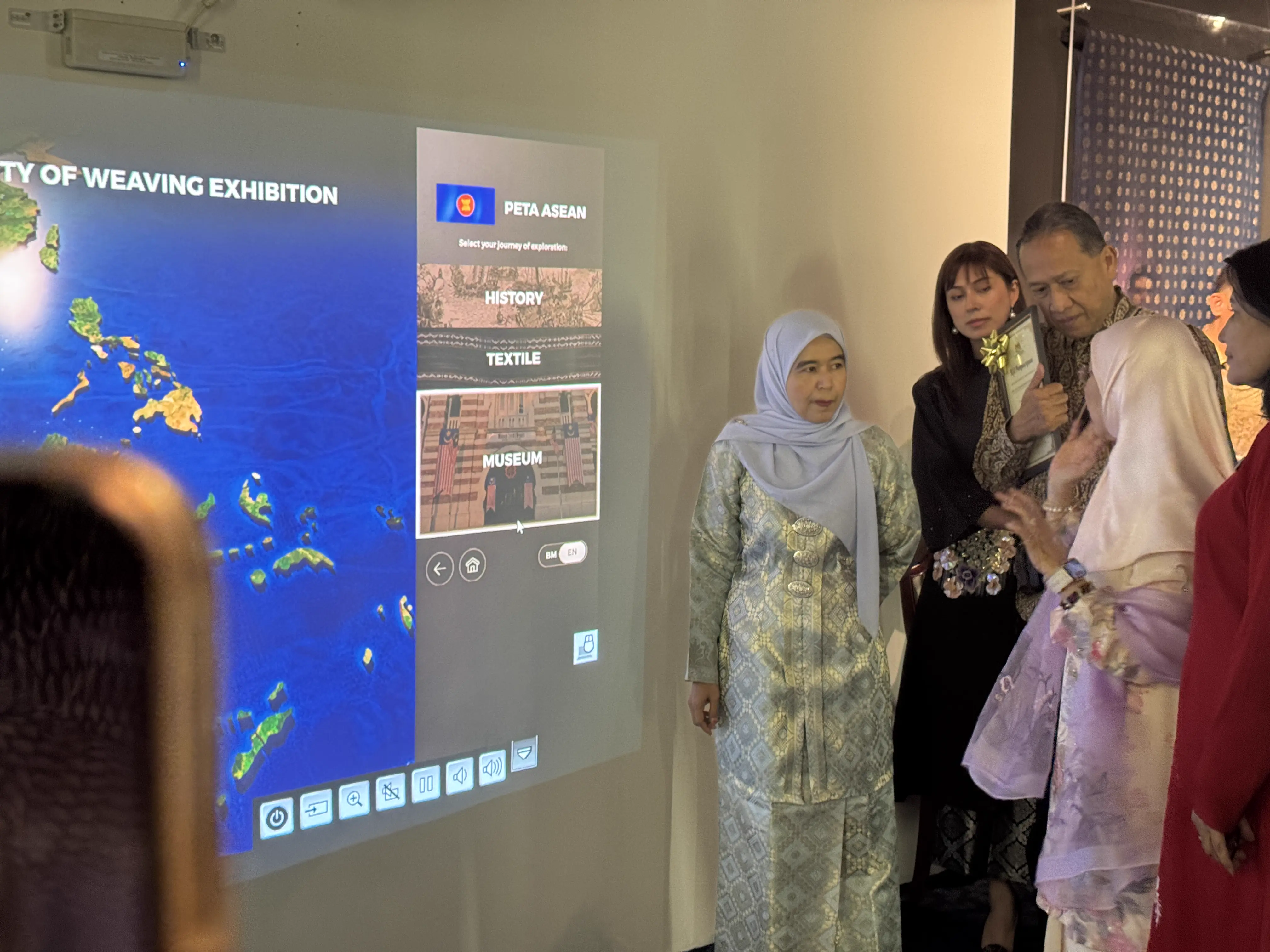 Guests of honour being shown the interactive Peta ASEAN menu at the exhibition launch