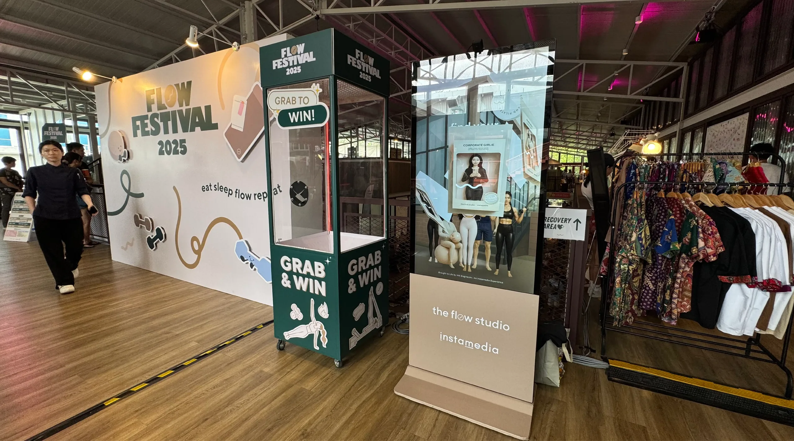 Flow Festival's claw machine and 'Flow Studio x Instamedia' photo booth stand side by side.