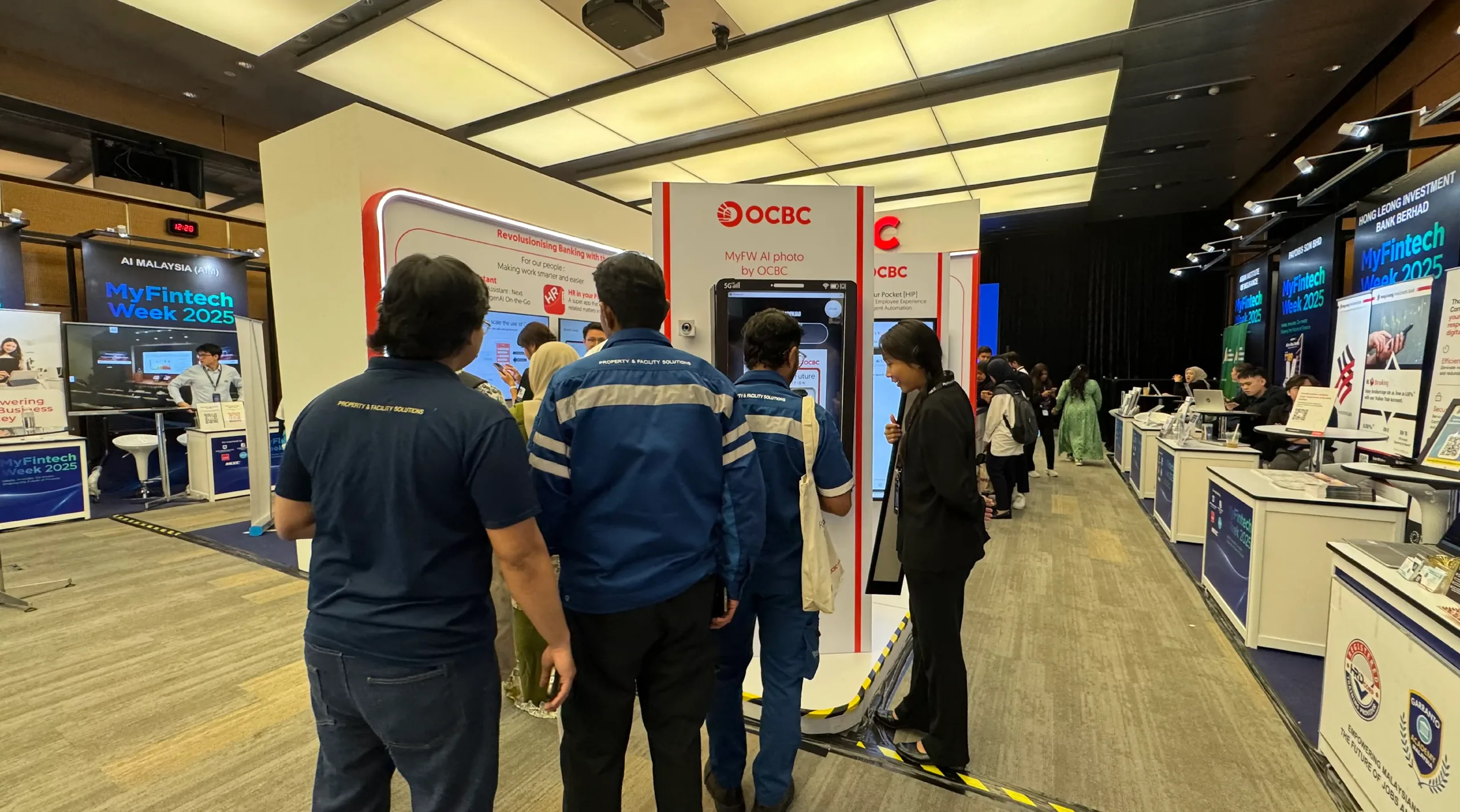 Staff and visitors queue at a branded AI photo kiosk during a fintech conference.