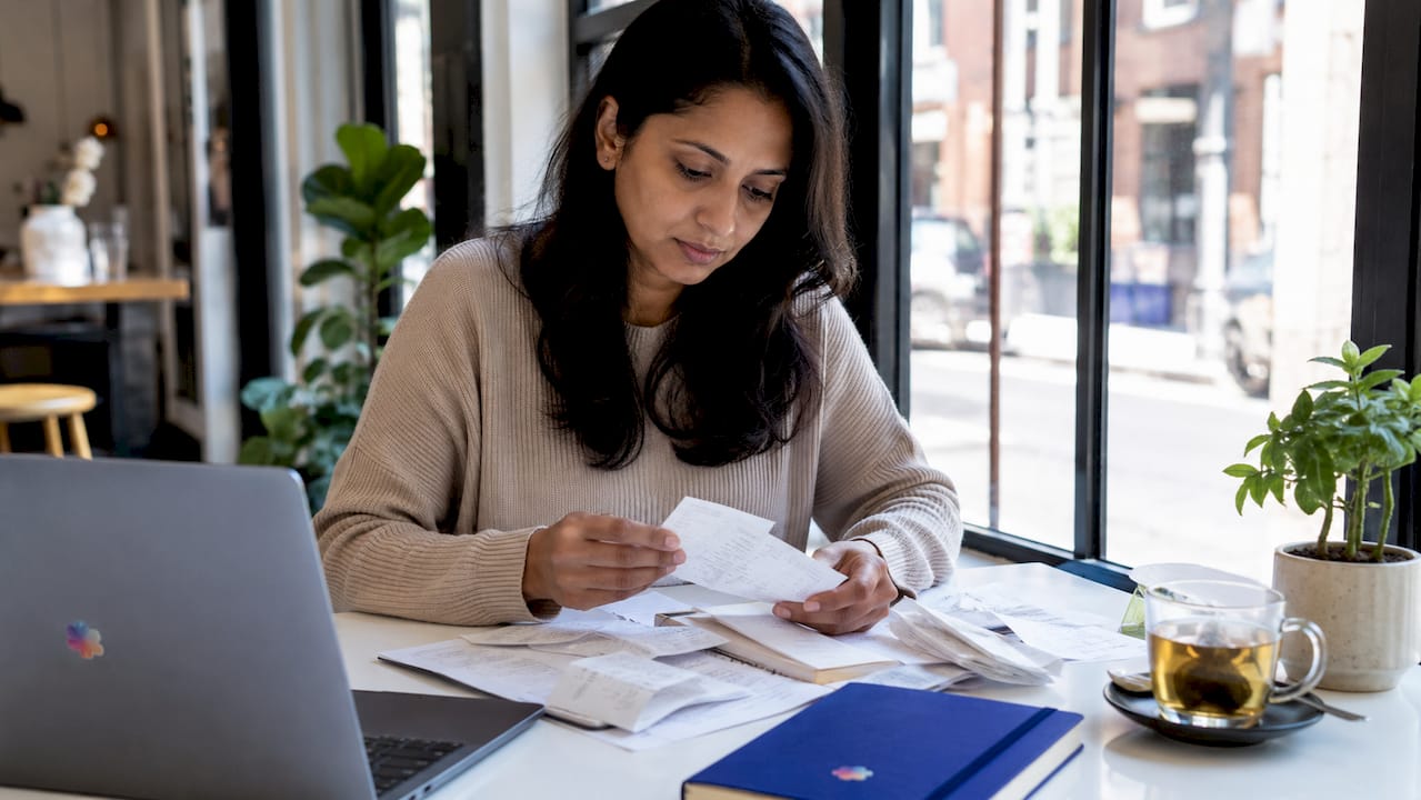 Woman organizing relocation expense receipts