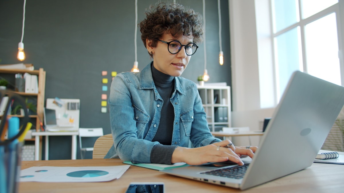 Woman working on a laptop in a modern office