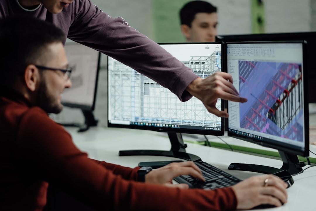 Engineers reviewing a digital design and BIM model together on screen