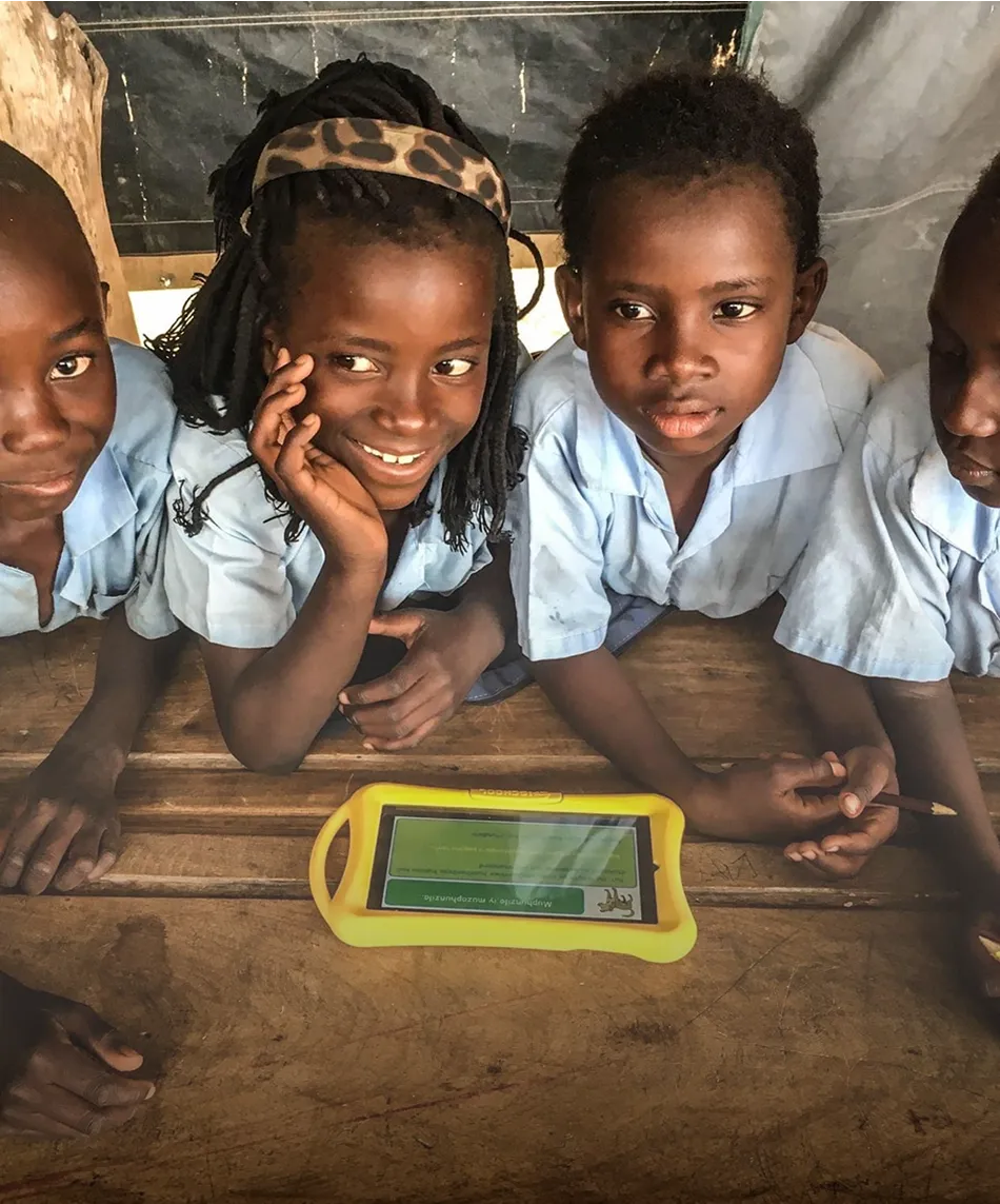 A group of young girls sitting next to each other.
