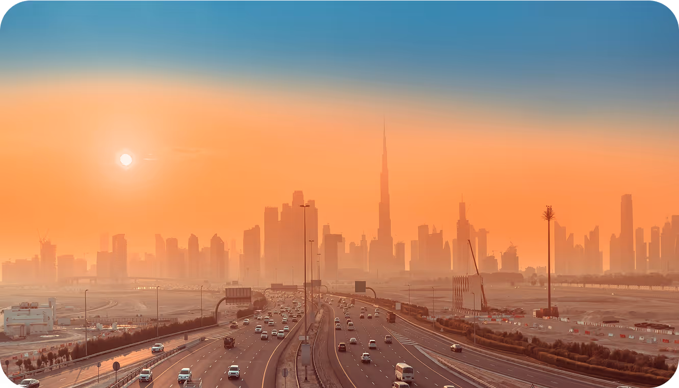 A view of a major city skyline at sunset.