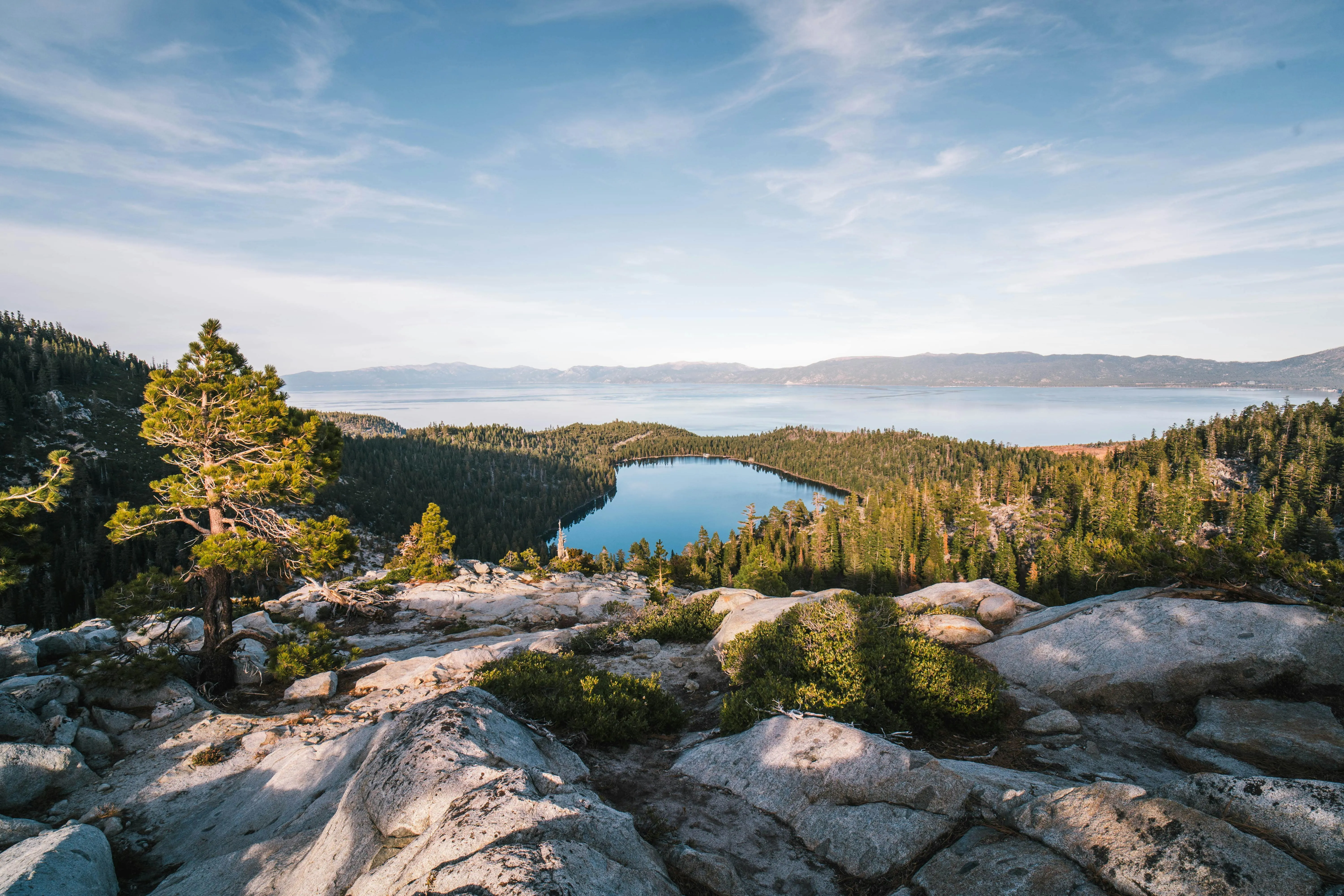 A view of a lake surrounded by rocks and trees.