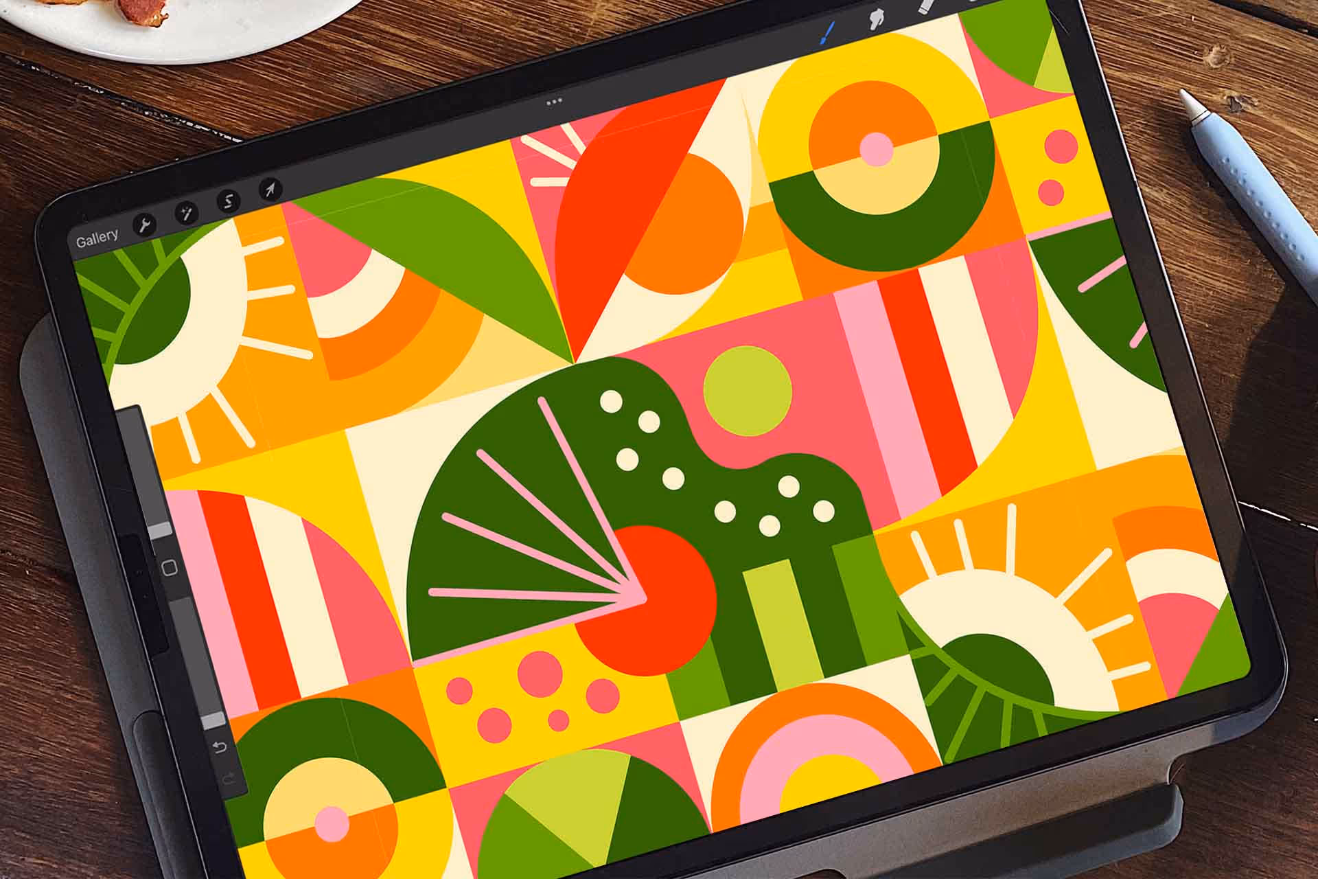 Tablet displaying colorful abstract geometric art with circles, leaves, and patterns in green, pink, orange, and yellow.