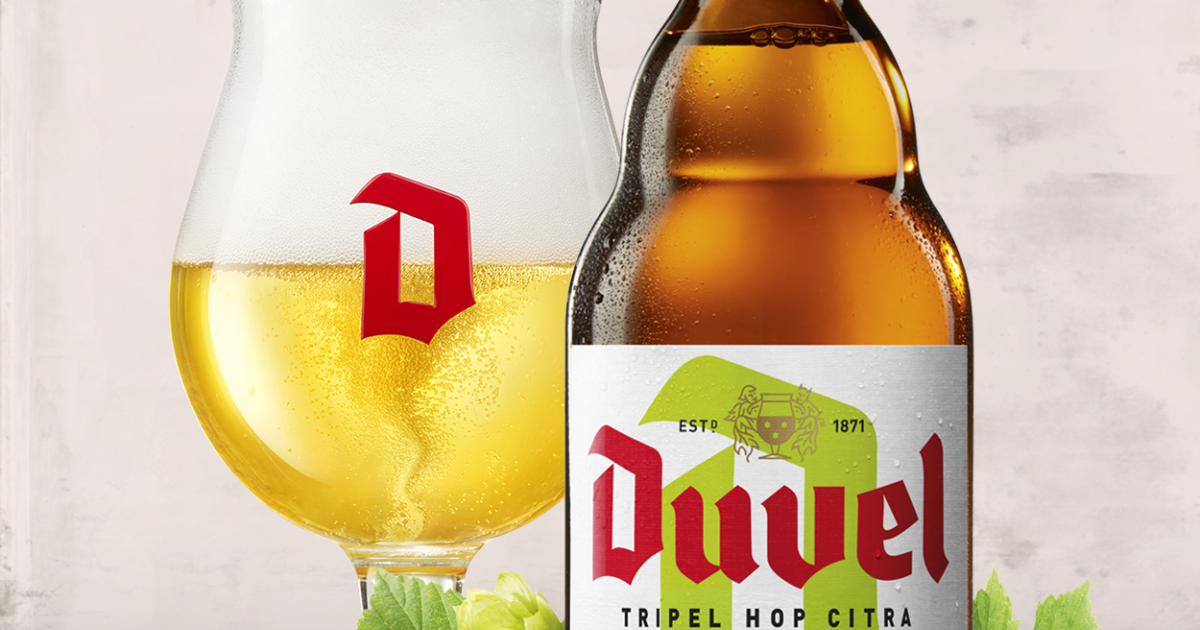 Verre et bouteille de bière Duvel Tripel Hop Citra, blonde dorée, mousse dense, logo rouge distinctif. L’étiquette met en avant le houblon Citra et l’année de création 1871, sur fond clair.