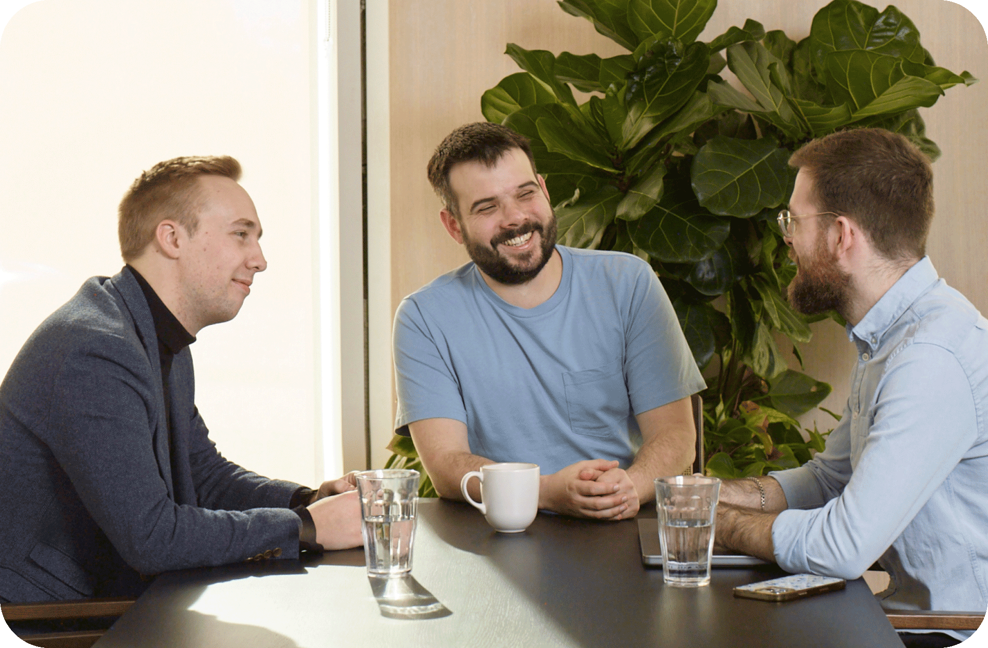 Three men sitting and talking