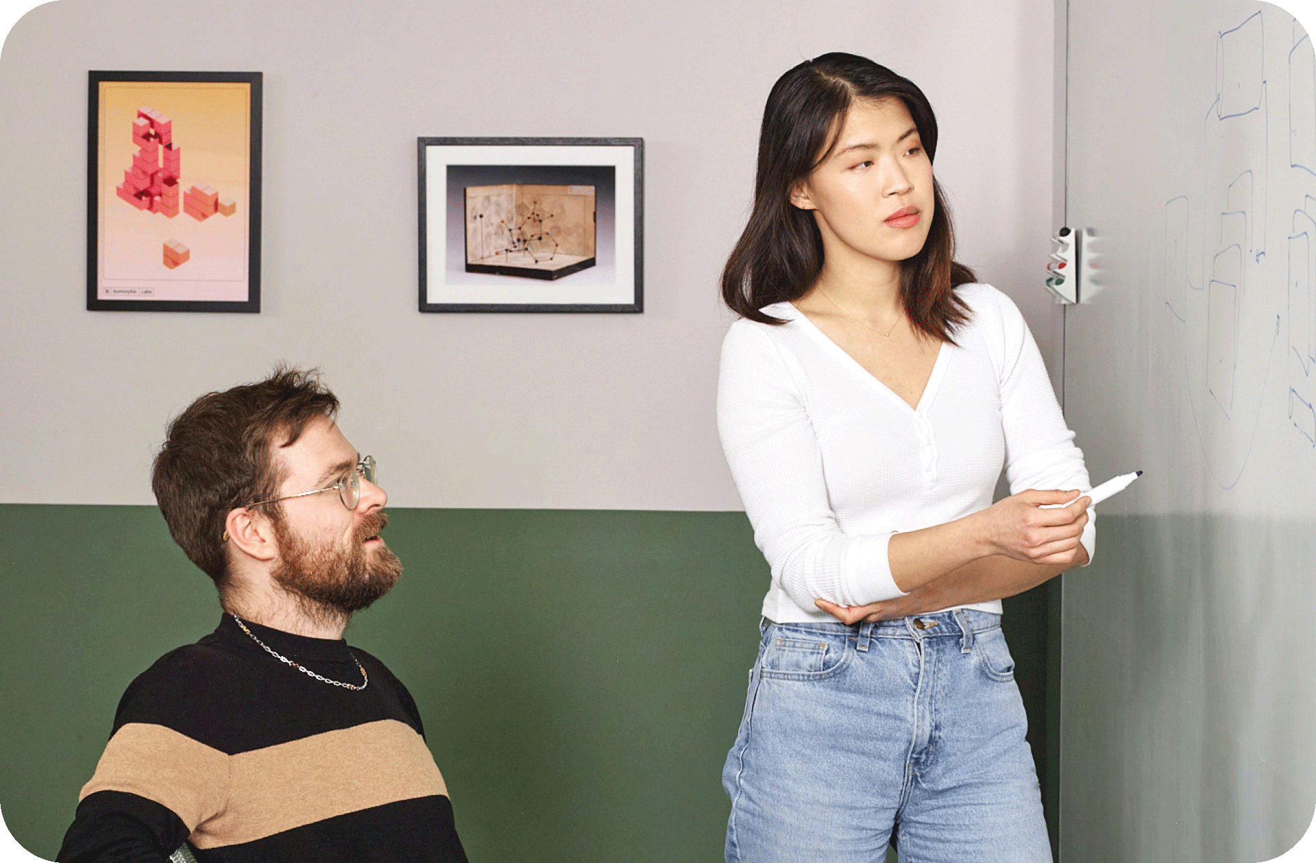 Two people discussing things on a board